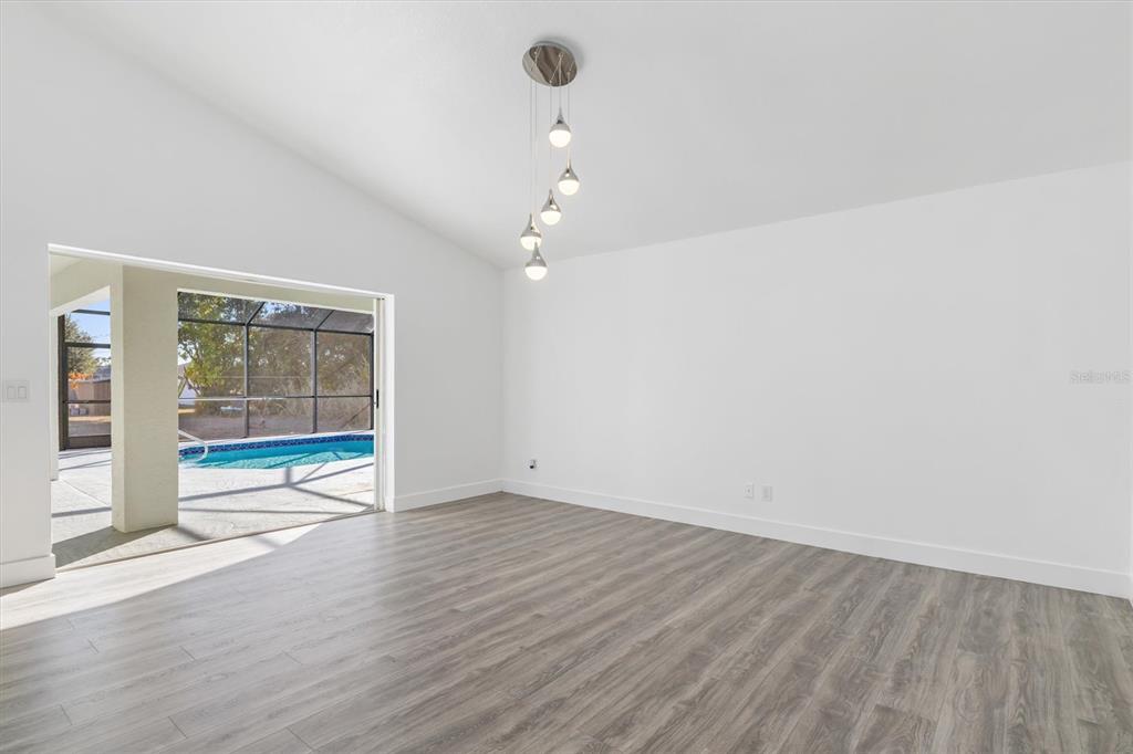 375 Waterside Street Port Charlotte, FL 33954 - Photo 24 of 49 wooden floor in an empty room with a window
