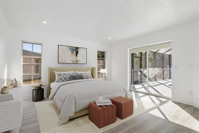 a bedroom with furniture and large windows