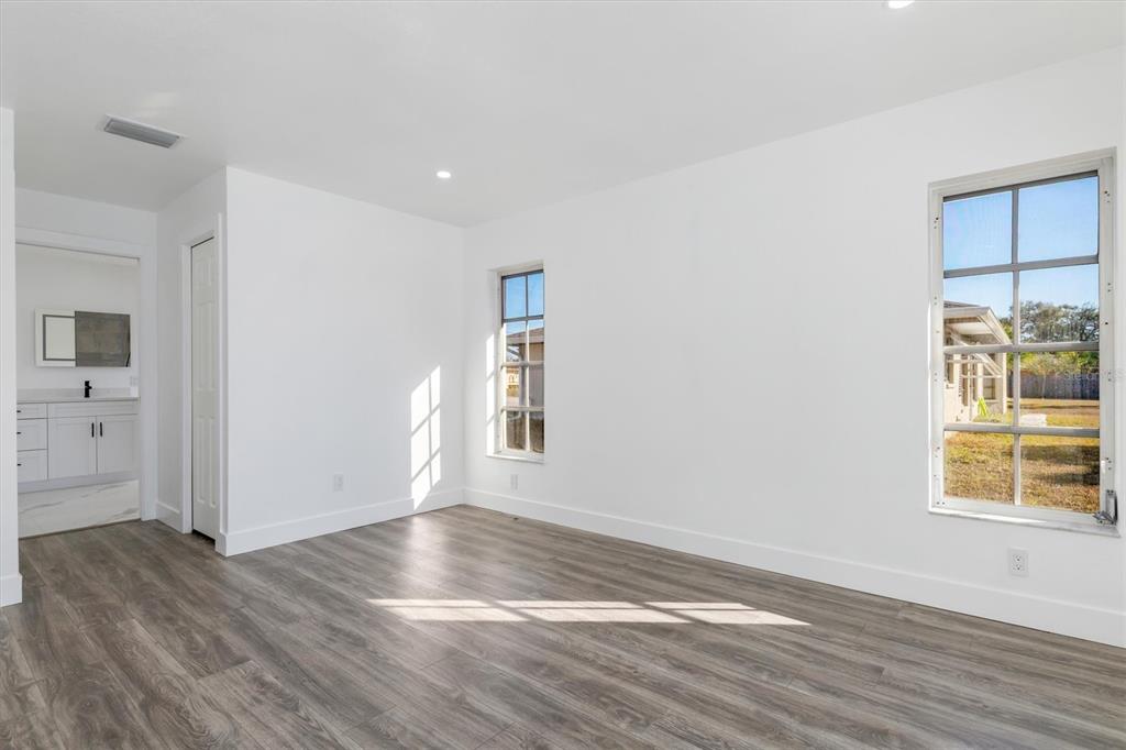 375 Waterside Street Port Charlotte, FL 33954 - Photo 27 of 49 wooden floor in an empty room with a window