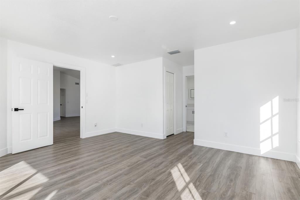 375 Waterside Street Port Charlotte, FL 33954 - Photo 28 of 49 a view of an empty room with wooden floor and window