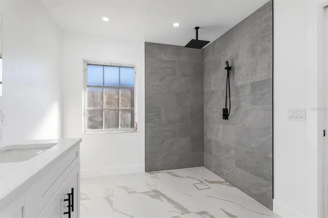 a bathroom with a shower and a sink