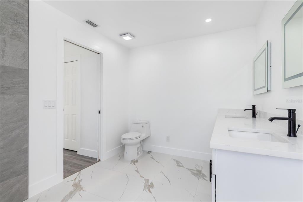 375 Waterside Street Port Charlotte, FL 33954 - Photo 32 of 49 a bathroom with a sink a toilet and a vanity