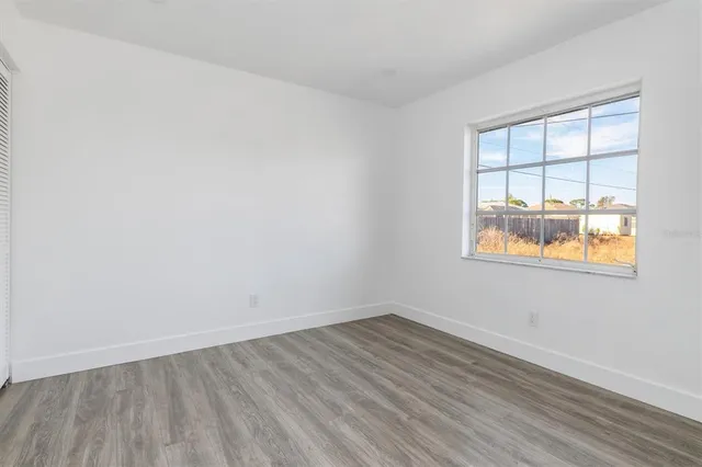 wooden floor in an empty room with a window
