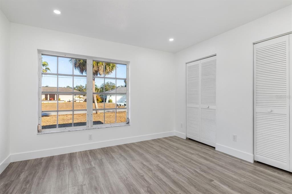 375 Waterside Street Port Charlotte, FL 33954 - Photo 36 of 49 an empty room with wooden floor and windows