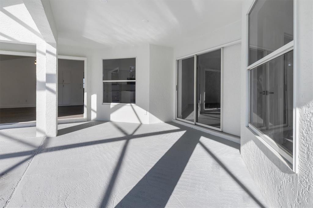 375 Waterside Street Port Charlotte, FL 33954 - Photo 39 of 49 a bedroom with a bed and glass door