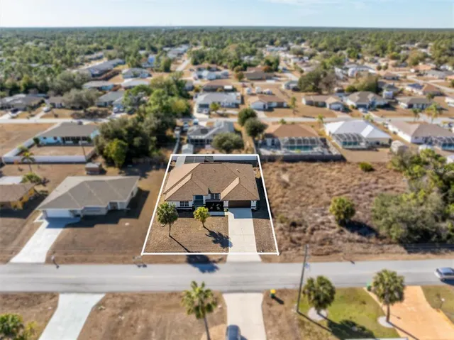 an aerial view of a house with a yard