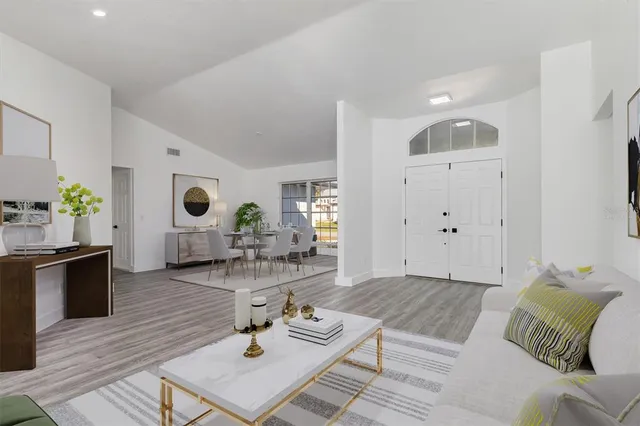 a living room with furniture and wooden floor