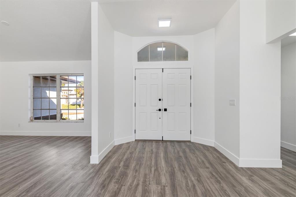 375 Waterside Street Port Charlotte, FL 33954 - Photo 8 of 49 an empty room with wooden floor and windows