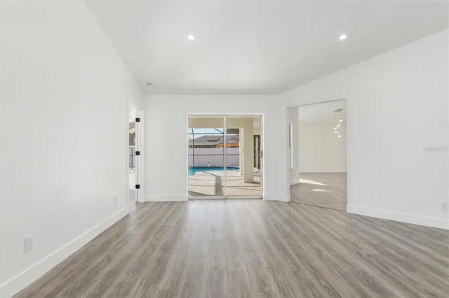 wooden floor in an empty room with a window