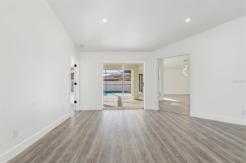 375 Waterside Street Port Charlotte, FL 33954 - Photo 10 of 49 wooden floor in an empty room with a window