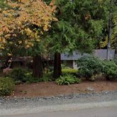 a front view of a house with a yard and a garage