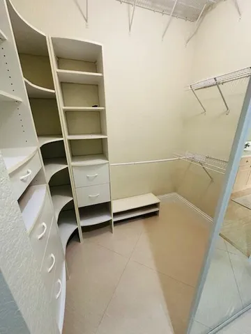 a living room with a balcony furniture and a dresser