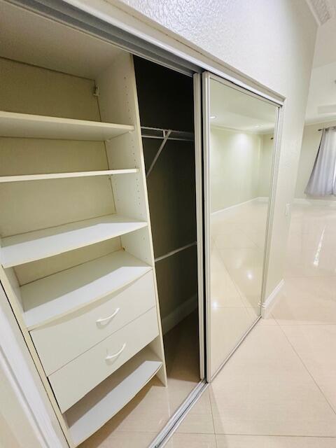 5245 Sancerre Circle Lake Worth, FL 33463 - Photo 24 of 46 a view of walk in closet with empty racks