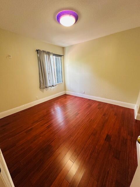 5245 Sancerre Circle Lake Worth, FL 33463 - Photo 30 of 46 a view of an empty room with wooden floor and a window