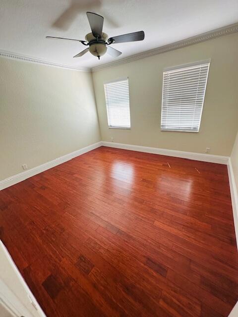 5245 Sancerre Circle Lake Worth, FL 33463 - Photo 34 of 46 an empty room with wooden floor chandelier fan and windows