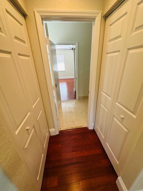 5245 Sancerre Circle Lake Worth, FL 33463 - Photo 36 of 46 a view of a hallway with wooden floor and staircase