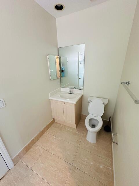 5245 Sancerre Circle Lake Worth, FL 33463 - Photo 39 of 46 a bathroom with a sink a toilet and mirror