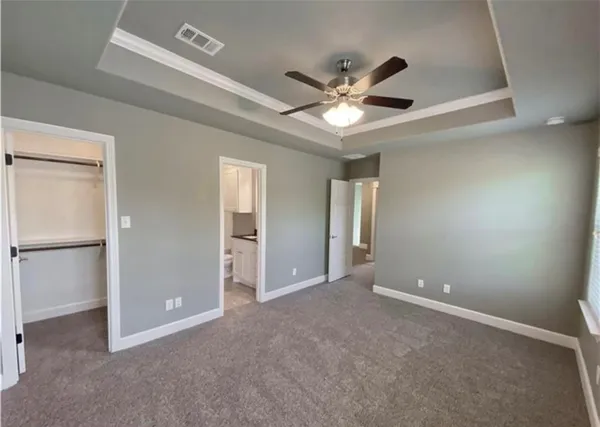 a view of an empty room with a ceiling fan