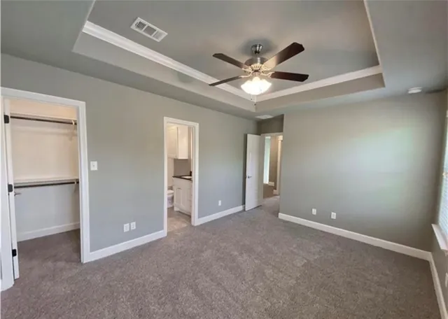 a view of an empty room with a ceiling fan