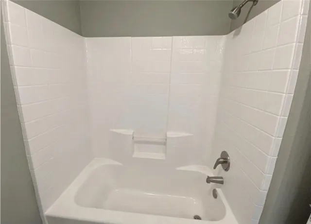 a white bath tub and shower