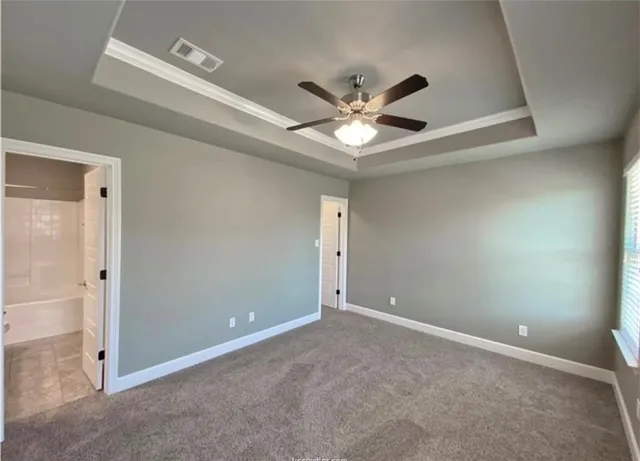 an empty room with a ceiling fan and a window
