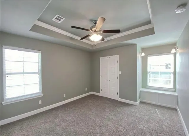 a view of a kitchen with wooden floor and a ceiling fan