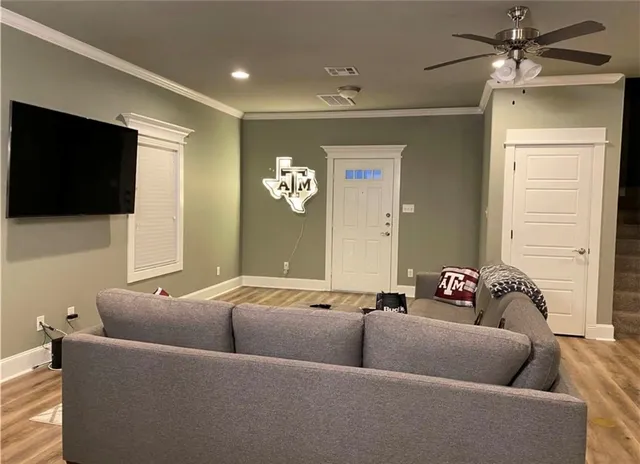 a living room with furniture and a flat screen tv