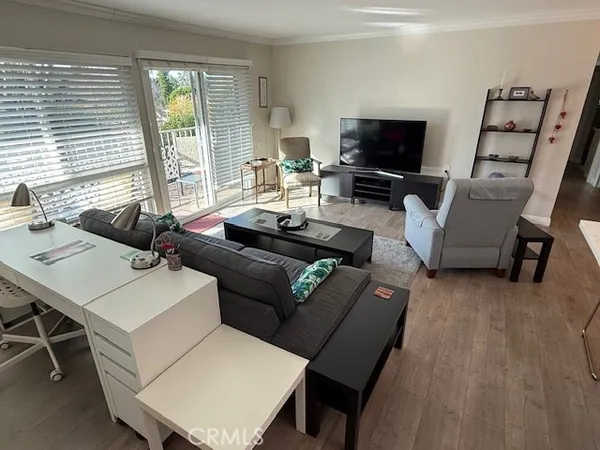 a living room with furniture a large window and a flat screen tv