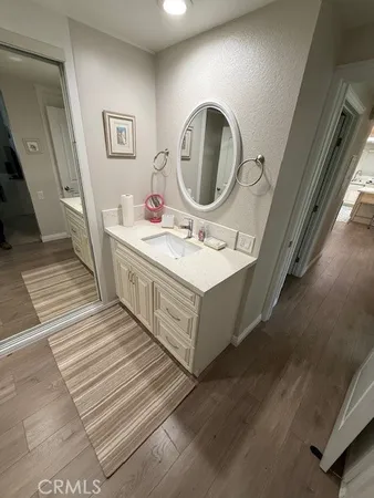 a bathroom with a sink mirror and vanity