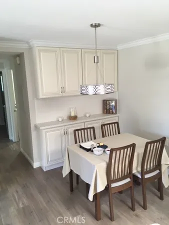 a view of kitchen with granite countertop cabinets table and chairs