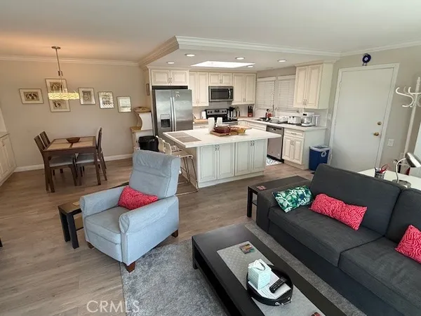a living room with furniture and kitchen view