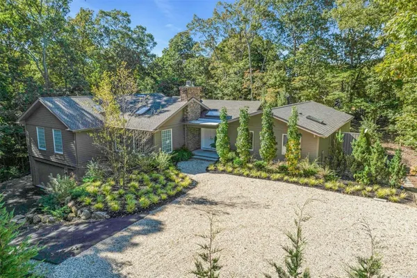 a front view of a house with a yard and a garage