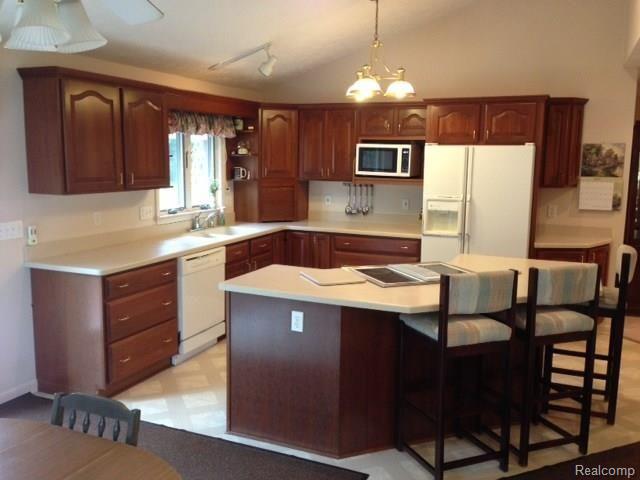 2198 West Barron Road Howell, MI 48855 - Photo 5 of 25 clean and open kitchen with bar seating