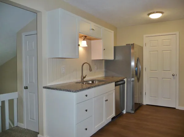 a bathroom with a toilet a sink a mirror and bathtub