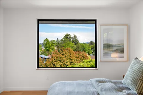 a view of a bedroom with a bed and a window