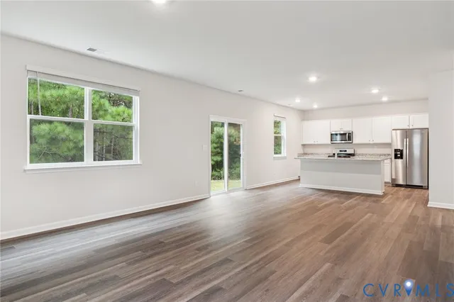 a view of kitchen with wooden floor electronic appliances and window