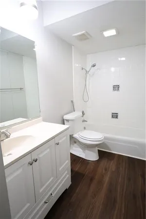 a bathroom with a double vanity sink toilet and shower