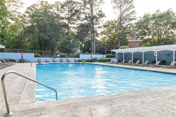 swimming pool view with a seating space