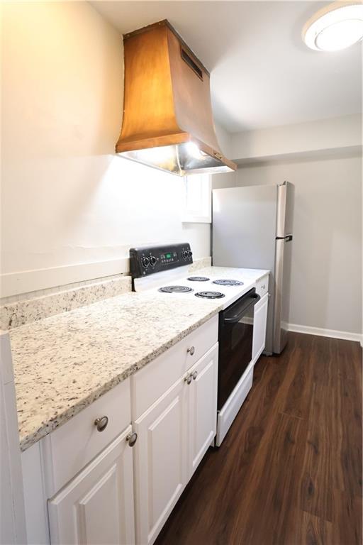 3091 Colonial Way, Unit H2 Chamblee, GA 30341 - Photo 5 of 17 a kitchen with stainless steel appliances granite countertop a sink a stove and a wooden floors