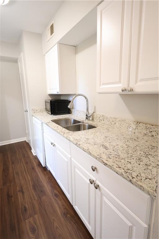 3091 Colonial Way, Unit H2 Chamblee, GA 30341 - Photo 6 of 17 a kitchen with granite countertop white cabinets and white appliances