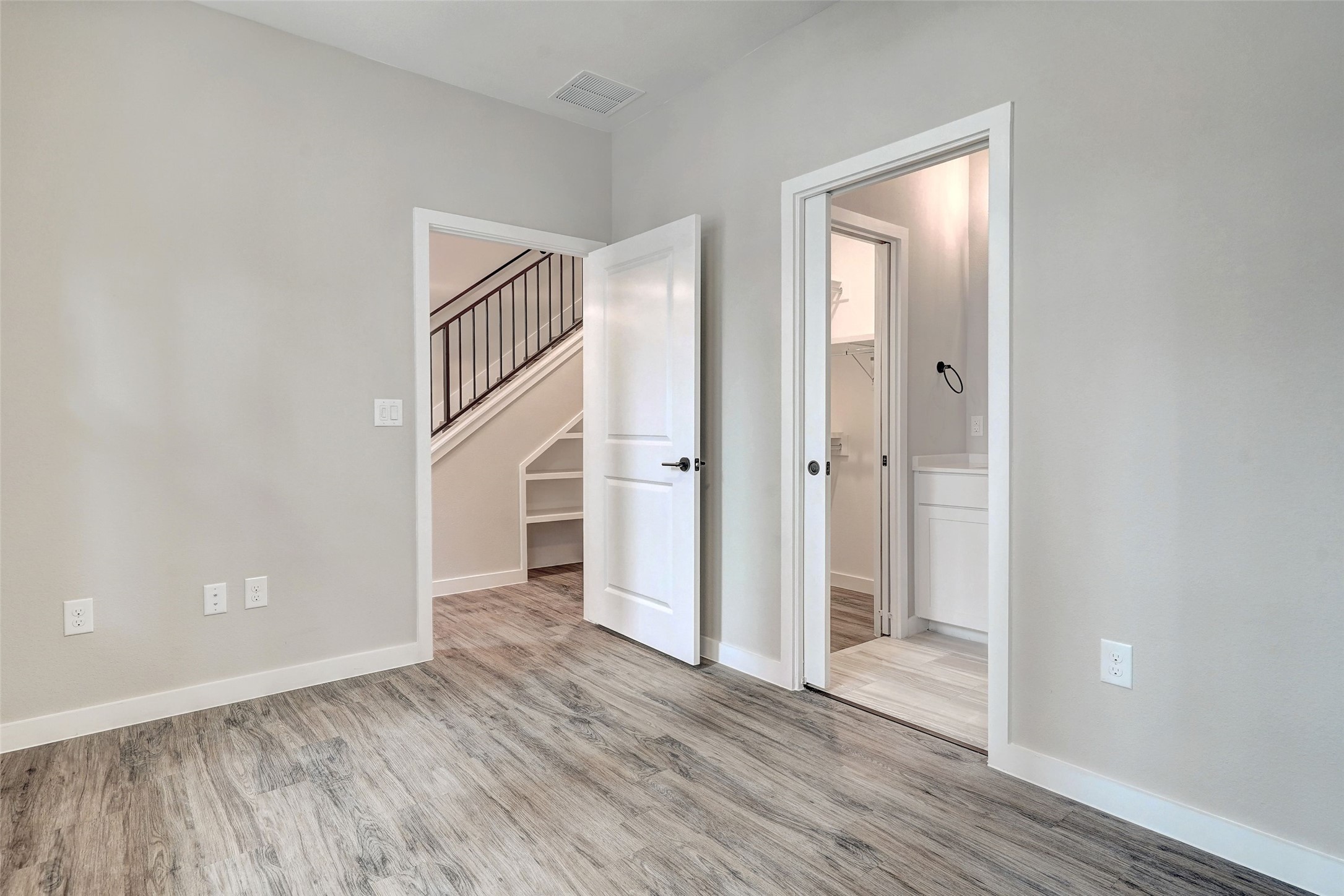 3809 Valley View Road, Unit 13 Austin, TX 78704 - Photo 6 of 27 an empty room with wooden floor and a bathroom