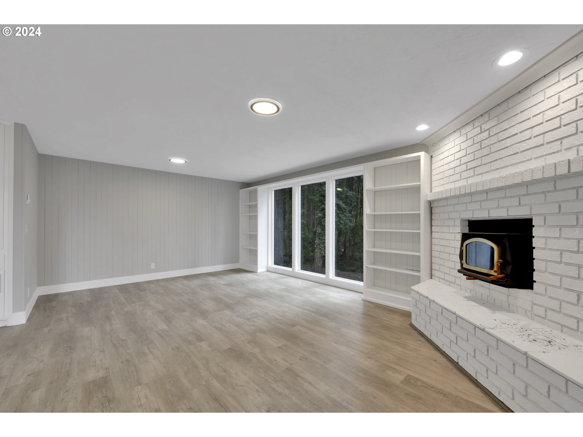 88164 Chita Loop Springfield, OR 97478 - Photo 12 of 48 a view of an empty room with wooden floor and a fireplace