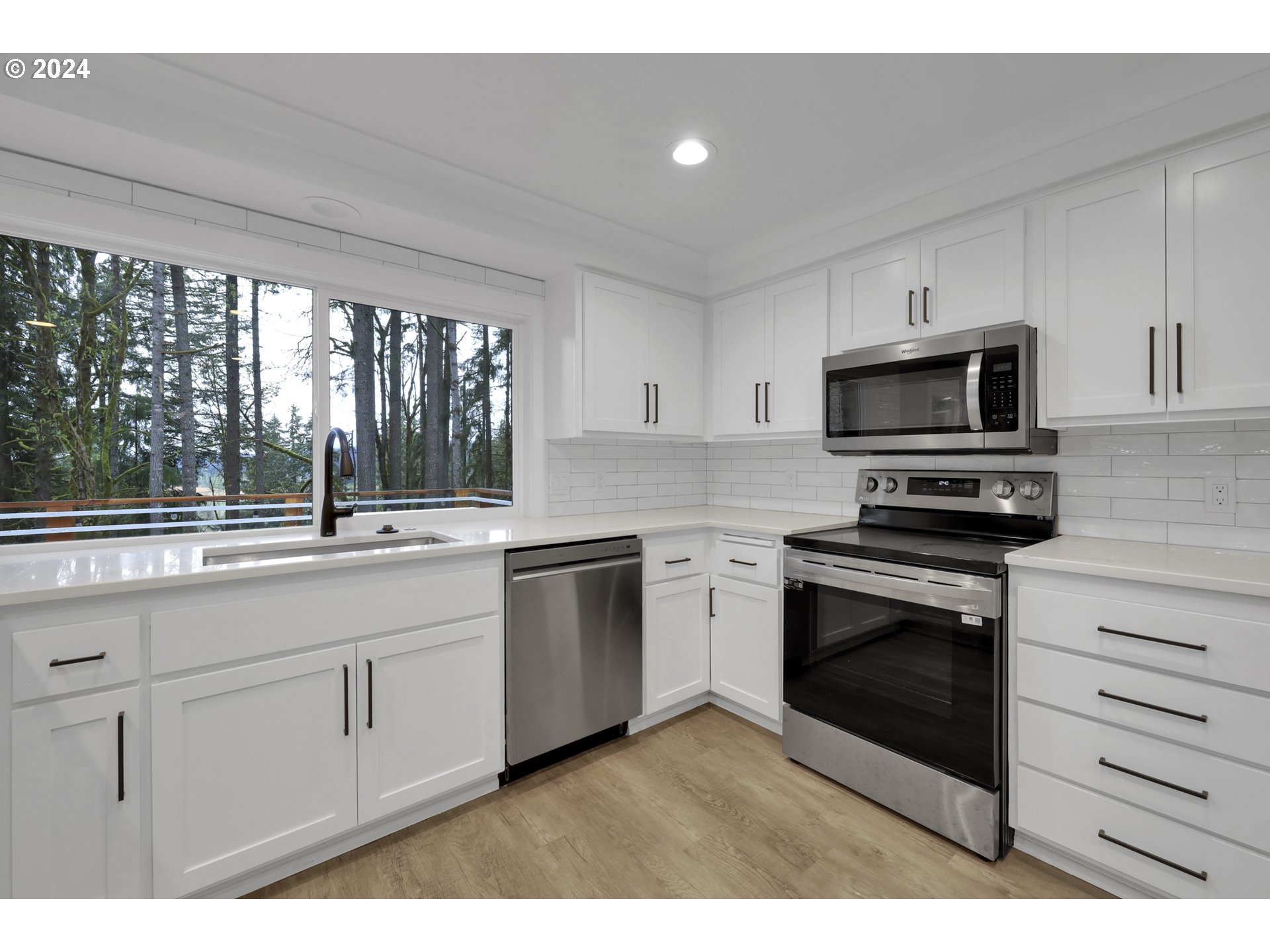 88164 Chita Loop Springfield, OR 97478 - Photo 17 of 48 a kitchen with granite countertop a stove a sink and a microwave