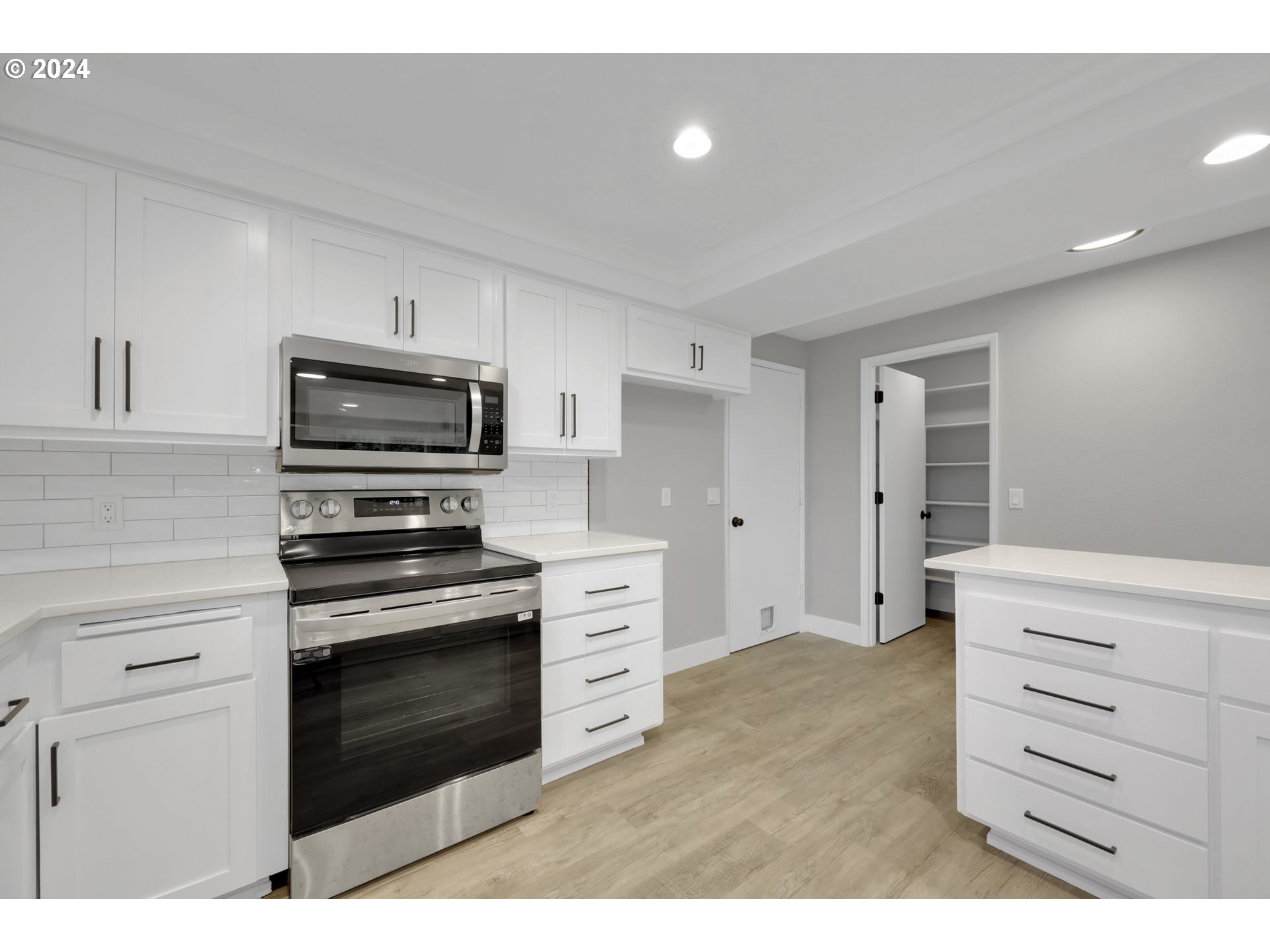 88164 Chita Loop Springfield, OR 97478 - Photo 18 of 48 a kitchen with white cabinets and appliances