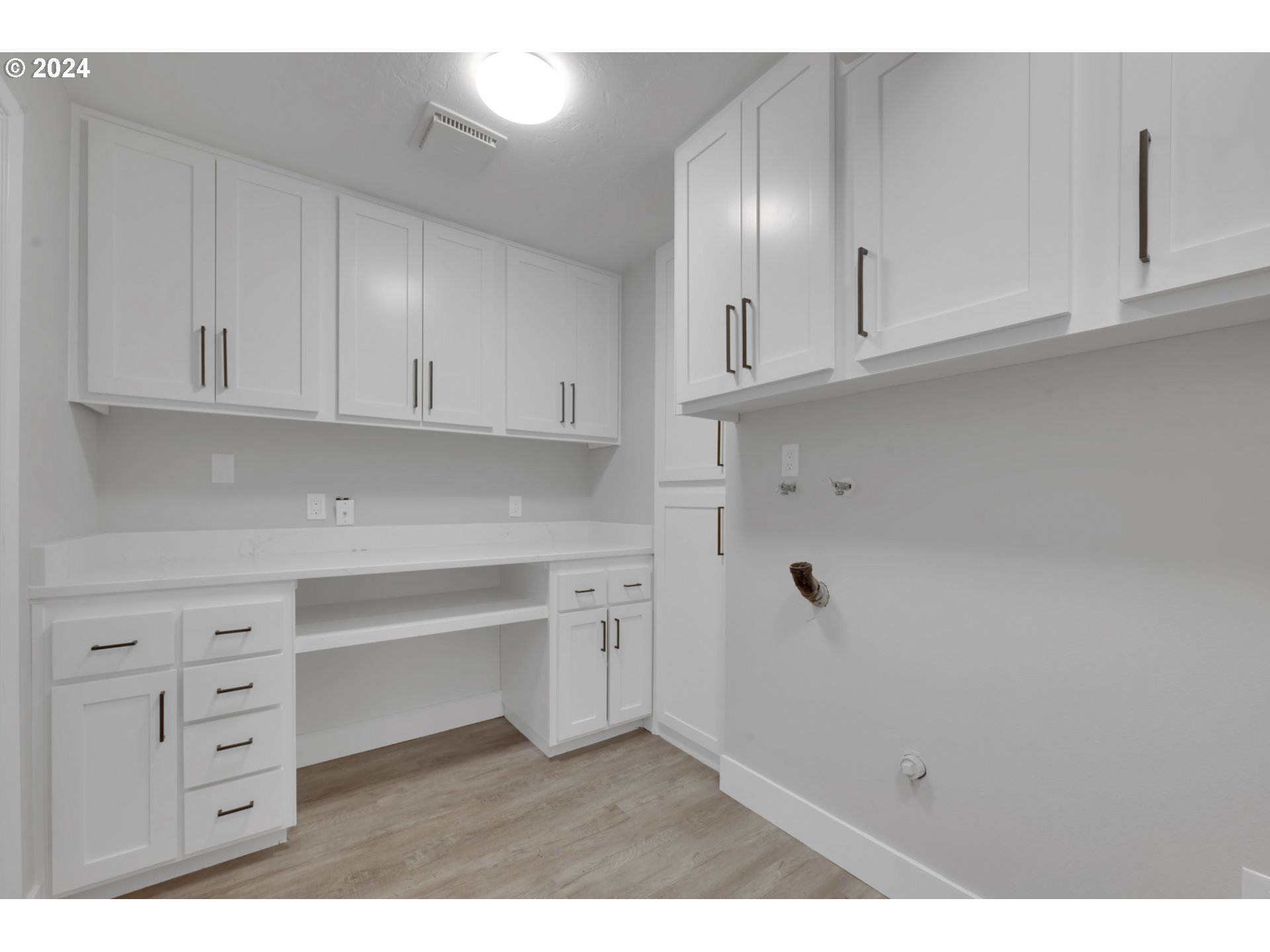 88164 Chita Loop Springfield, OR 97478 - Photo 20 of 48 a kitchen with white cabinets and a stove with white walls