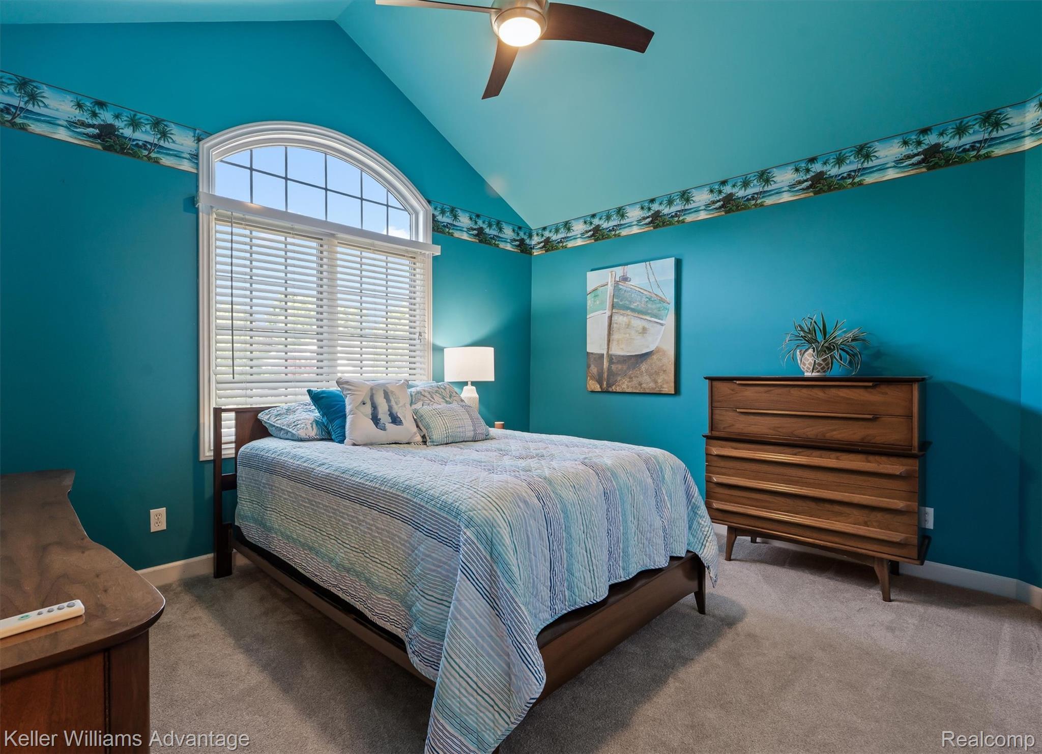 22878 Tree Top Court South Lyon, MI 48178 - Photo 27 of 75 Vaulted ceiling featuring a ceiling fan, arched window with horizontal blinds, and wall-to-wall carpeting