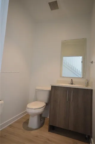 a bathroom with a toilet and a window