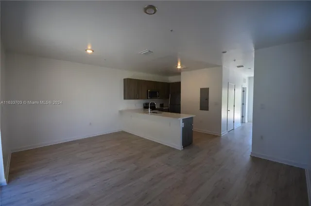 a view of kitchen with cabinets and wooden floor