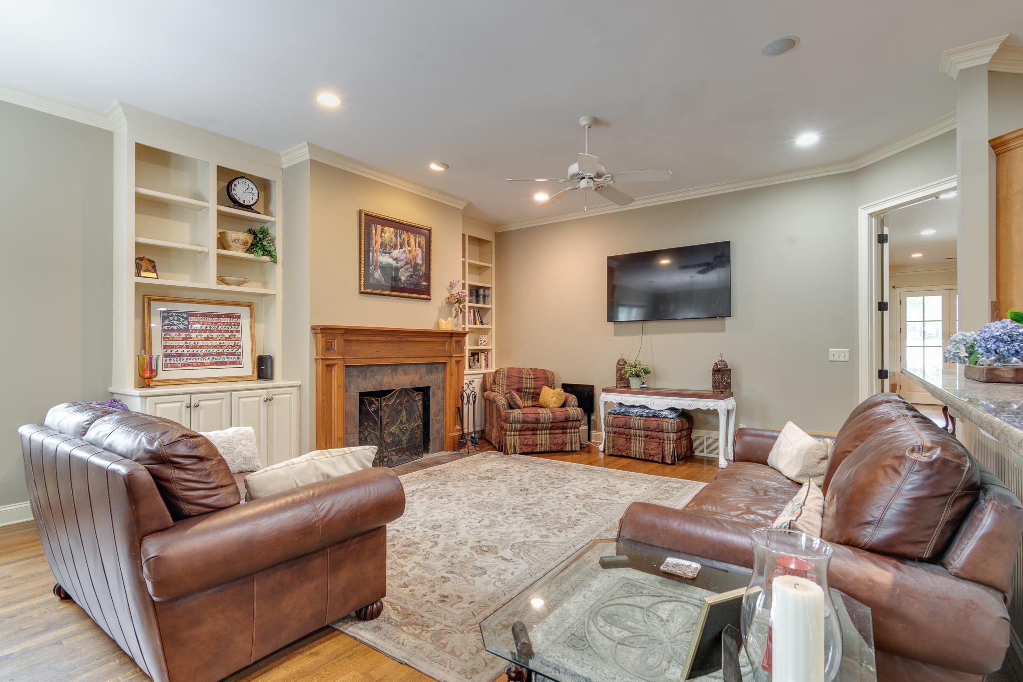 226 North White Station Road Memphis, TN 38117 - Photo 11 of 31 Living room featuring light hardwood / wood-style floors, crown molding, a premium fireplace, and ceiling fan