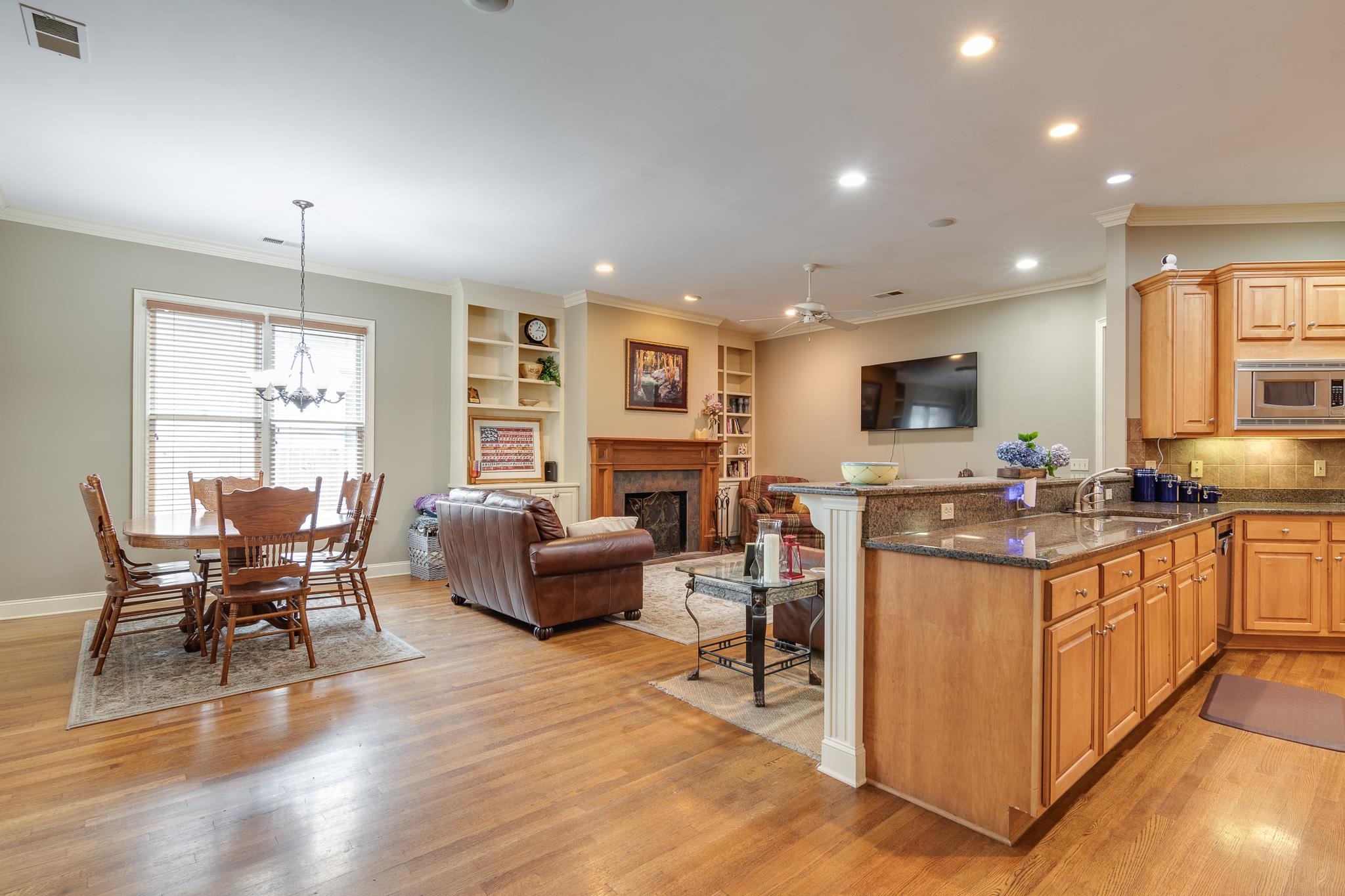 226 North White Station Road Memphis, TN 38117 - Photo 13 of 31 Kitchen with stainless steel microwave, tasteful backsplash, light wood-type flooring, and ornamental molding